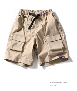Detail of khaki cargo shorts with elastic waist and adjustable quick-release buckle belt