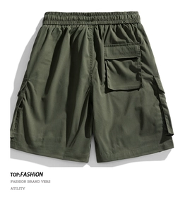 Detail view of army green cargo shorts featuring high-density stitching and flap pockets