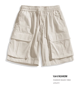 Detail of beige cargo shorts showing elastic drawstring waist and side flap pockets