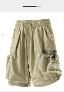 Detailed view of cargo shorts with elastic drawstring waist and 3D utility pockets