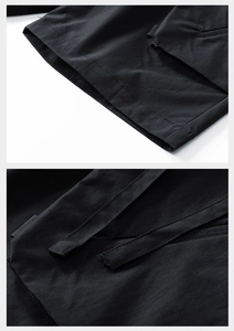 Detailed stitching on black cargo shorts with functional pockets and woven texture