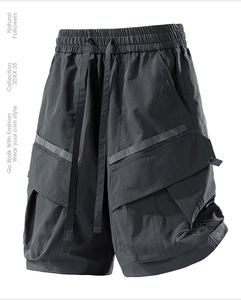 Detail of dark grey cargo shorts with 3D flap pockets and elastic drawstring waistband