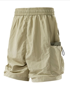 Detail of beige cargo shorts with elastic waistband and functional side pockets