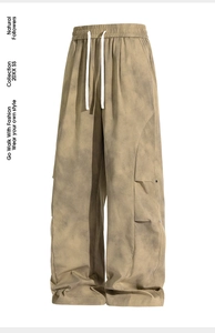 Detail of wide-leg cargo pants with tie-dye wash, elastic waist and drawstring