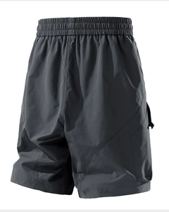 Detail of dark grey cargo shorts featuring elastic waistband and functional fabric texture
