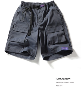 Close-up of cargo shorts showing drawstring waist, buckle belt and side flap pockets