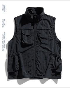 Detail of black outdoor utility vest showing tactical pockets and durable nylon fabric