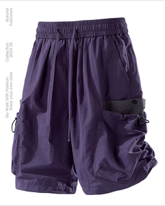 Detail of dark purple cargo shorts with elastic drawstring waist and tactical pockets