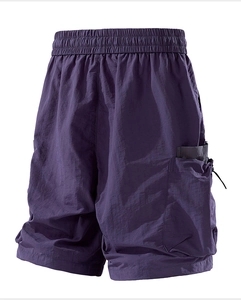 Detail view of deep purple cargo shorts with elastic waist and 3D utility pockets