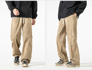 Detail showing khaki cargo pants with drawstring waist and large side 3D utility pockets