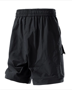 Detailed view of black cargo shorts featuring elastic waistband and large side flap pockets