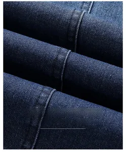 Close-up of dark navy blue denim blazer fabric showing wrinkle-resistant texture