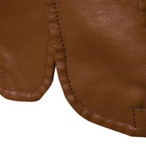 Close-up of brown PU leather texture and premium stitching on slim fit jacket hem
