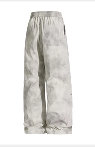 Detail view of tie-dye lounge pants back pocket and side silver metal button accents