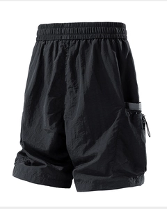 Detail of black tactical shorts showing elastic waistband and functional cargo side pocket