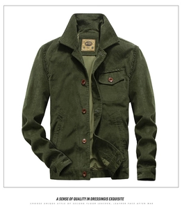 Detail of vintage dark green corduroy jacket with flap pocket and classic buttons