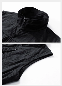 Close-up of black outdoor vest featuring waterproof fabric and stand-up collar details