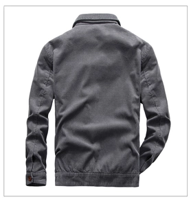 Detail view of the back of a dark grey corduroy jacket with ribbed texture and hem detail