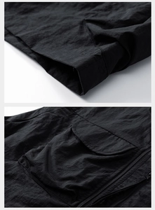 Detail of a black functional outdoor vest showing premium stitching and 3D cargo pockets