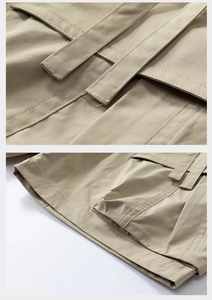 Detail of khaki cargo shorts showing reinforced double stitching and functional straps