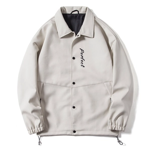 Detail of off-white lapel jacket with Perfect script embroidery and snap buttons