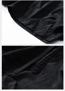 Detailed view of black nylon shorts featuring reinforced double stitching and durable drawstrings