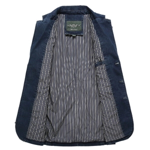 Detailed view of dark blue casual jacket showing striped lining and collar label