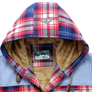 Detail view of the warm faux shearling lining and plaid fabric on the hooded shirt