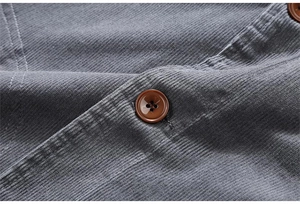 Detail of grey corduroy texture with vintage brown button on men's casual jacket