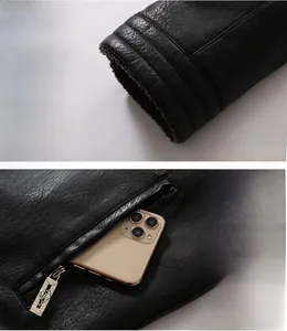Detail of men's black faux leather jacket showing fleece lining and metal zipper pocket