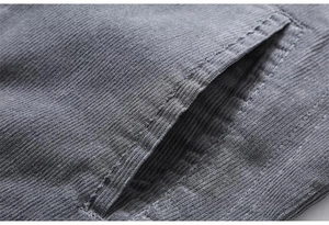 Detail of gray corduroy jacket pocket showing high-quality stitching and ribbed fabric texture