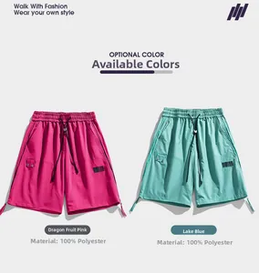 Detail of pink and blue cargo shorts with drawstring waist and textured polyester fabric