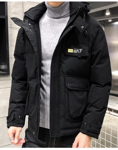 Detail of black winter hooded jacket with multi-pocket design and windproof fabric