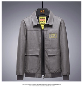 Detail of grey PU leather jacket showing ribbed cuffs and dual chest flap pockets