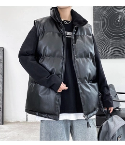 Detail of men's puffer vest showing stand collar with black faux fur lining and metal zipper