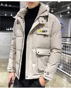 Detailed view of beige hooded puffer jacket with black chest logo and windproof fabric