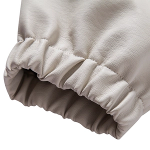 Detail of the elastic ribbed cuff on a beige faux leather jacket for men