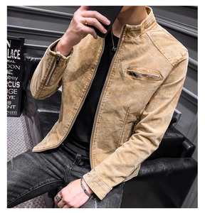 Detail of mustard yellow cotton jacket showing standing collar and metal zipper pocket
