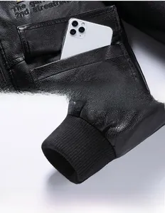 Detail view of lychee texture black PU leather jacket with flap pocket and ribbed cuffs