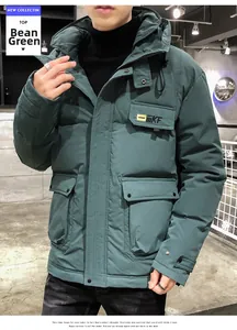 Detail of hooded winter jacket in bean green with KF logo and large flap pockets