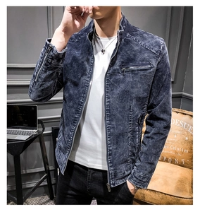 Detail of dark blue washed denim jacket featuring a stand collar and silver zippers