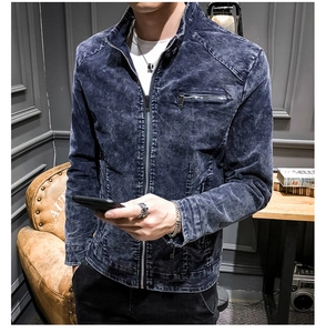 Detail of dark blue acid wash denim jacket with stand collar and zipper pocket