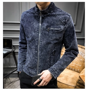 Detail of vintage washed blue denim jacket featuring metal zipper and stand collar