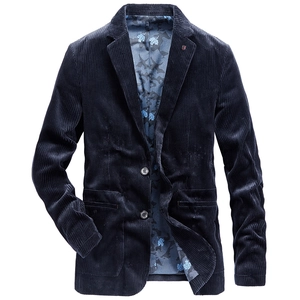 Macro detail of navy corduroy blazer showing texture, lapel pin, and leaf print lining