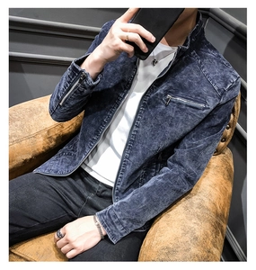 Detail of navy blue washed denim jacket with stand collar and zipper pockets
