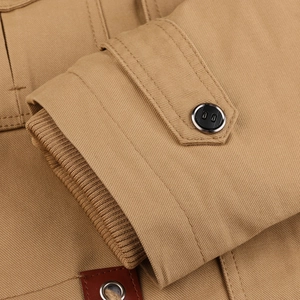 Detailed close-up of khaki jacket sleeve with ribbed storm cuffs and adjustable strap