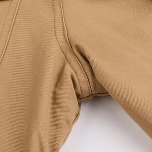 Detailed macro shot of khaki twill canvas fabric with reinforced double stitching