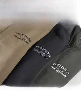 Detail of fleece lining and fabric texture in camel, black, and dark gray winter coats