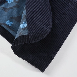 Detail of navy corduroy fabric with stylish blue maple leaf camouflage pattern lining