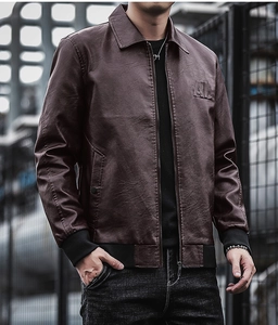 Detail of dark brown leather jacket featuring a high-quality metal zipper and AL embossed logo